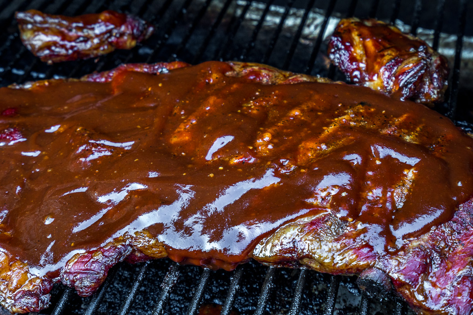 Cover smoked spare ribs in bbq sauce